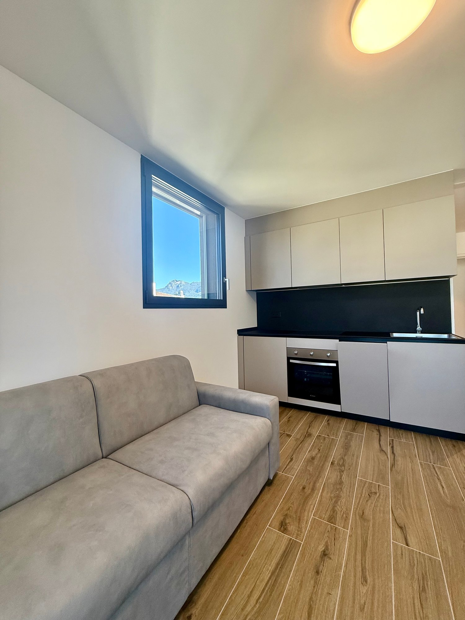 modern apartment, open kitchen, living area, large window