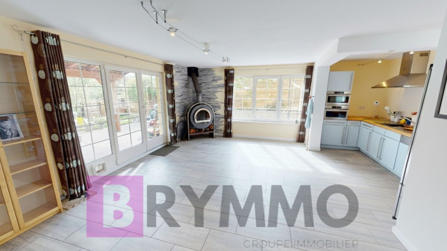 white floor, open plan, fireplace, glass doors, cabinets, oven