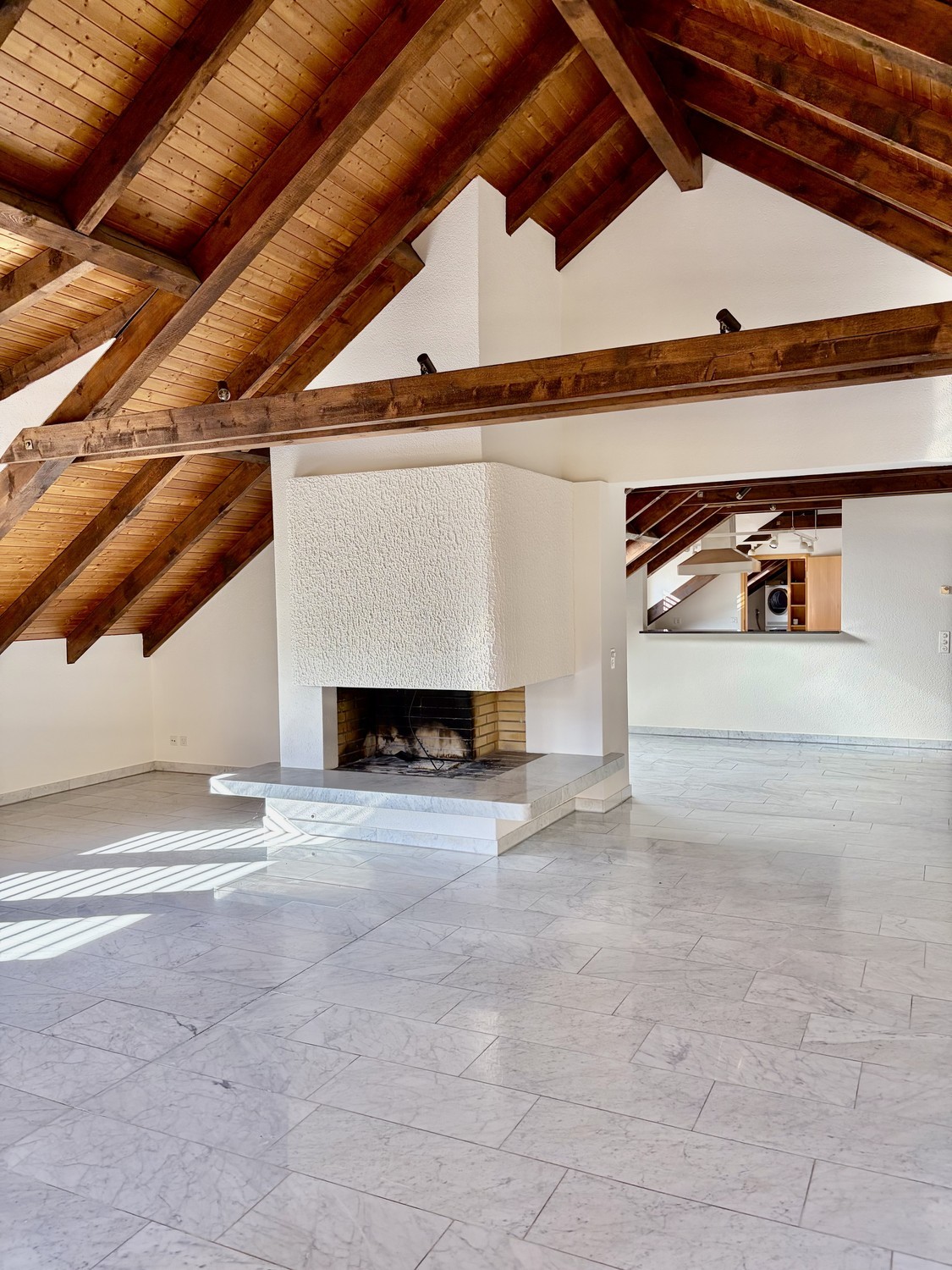 Empty room with a fireplace, white tiled floor, and wooden ceiling