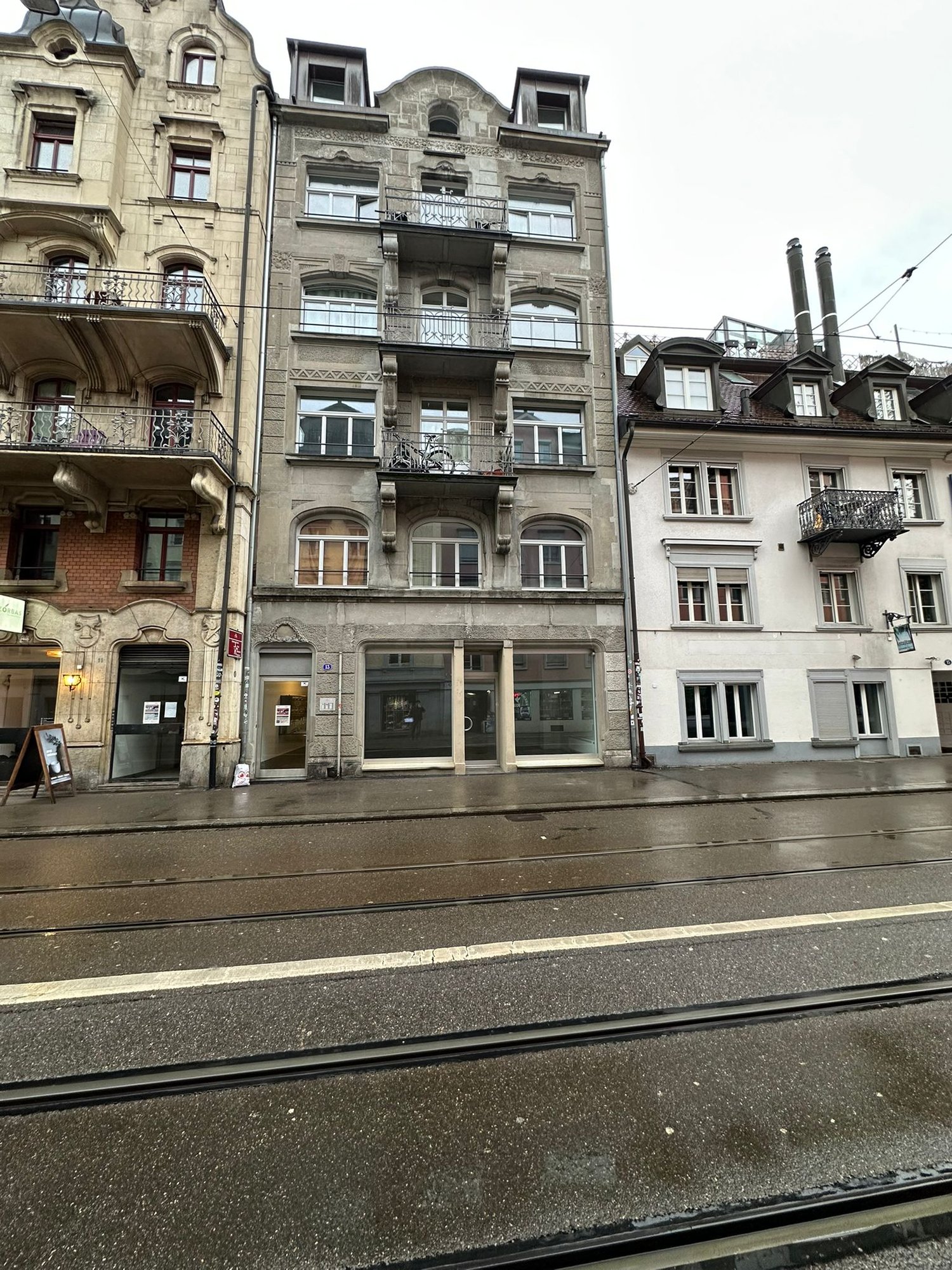 5 story building, balconies, stone exterior, windows, street front
