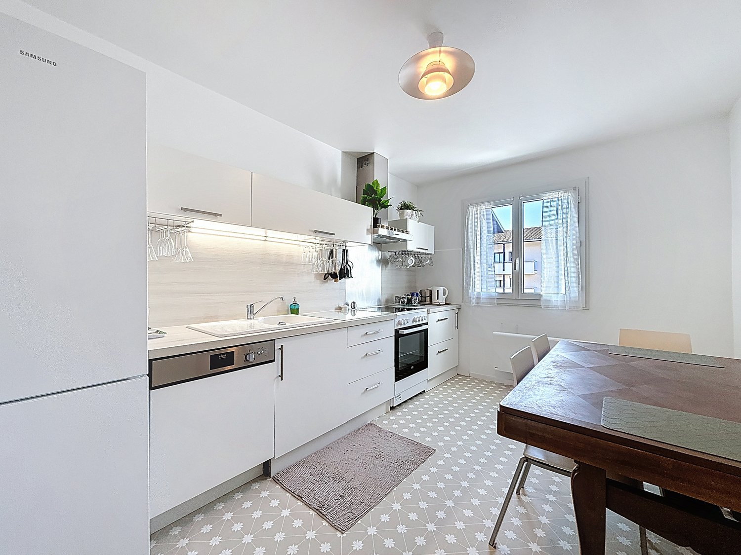 modern kitchen with white cabinets, stainless steel appliances, white tiled floor, sink, dishwasher, oven, window with curtains