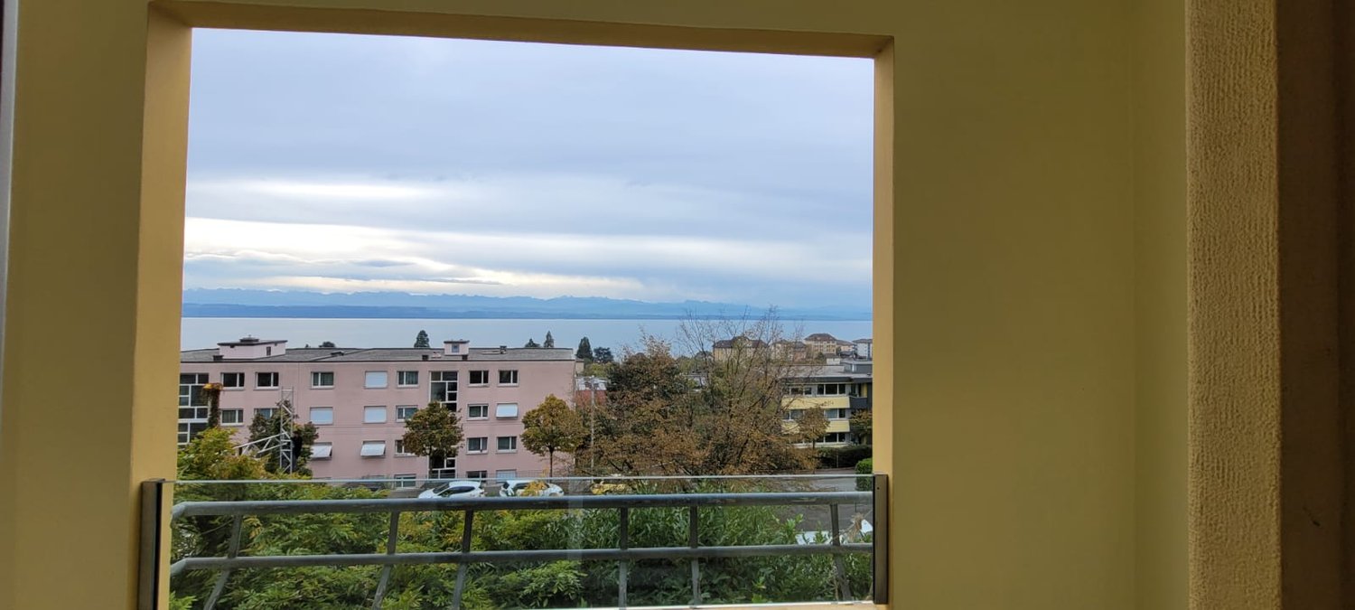 a room with a view of the sea and mountains