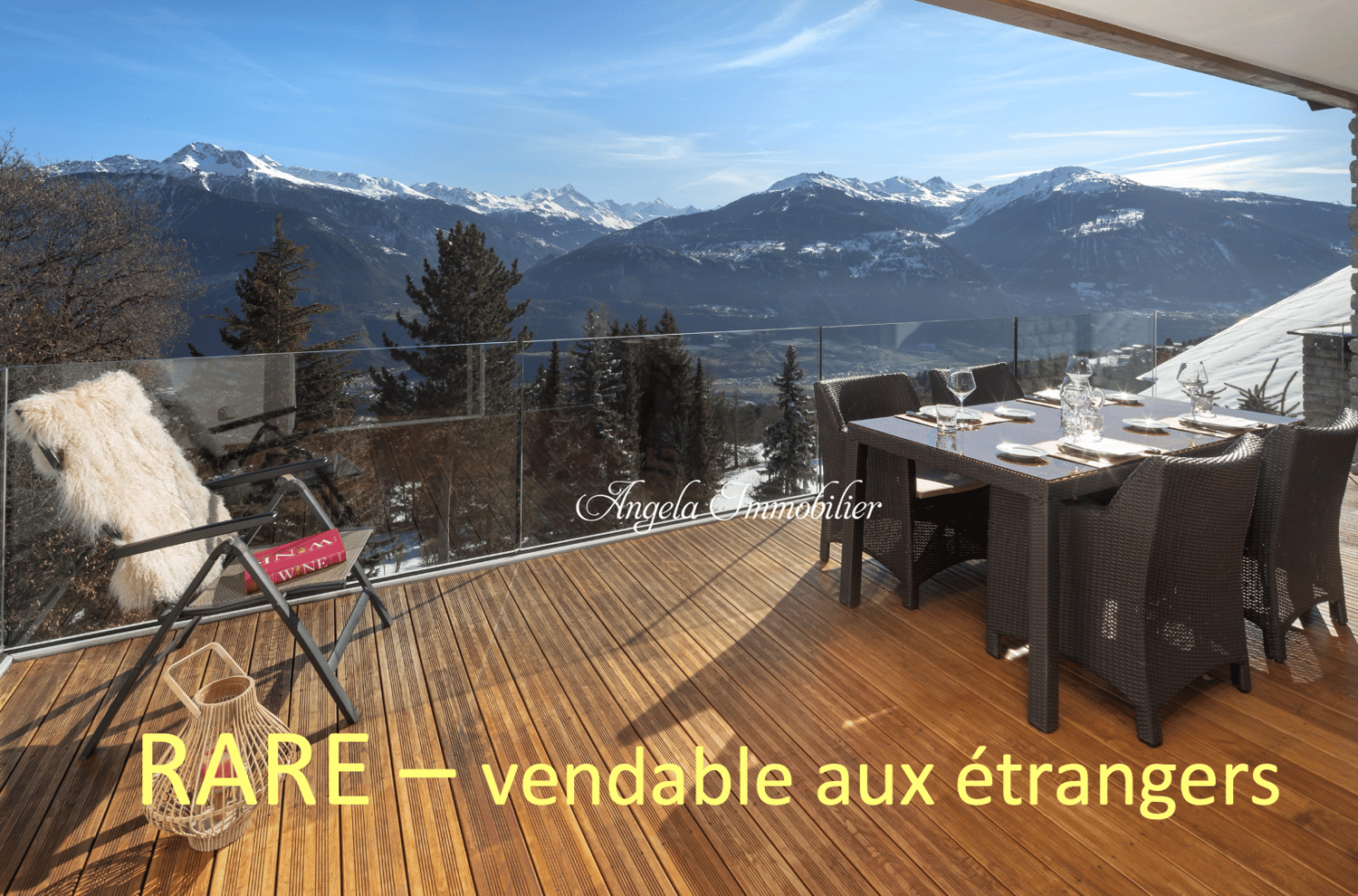 Wooden deck, glass railing, outdoor dining table, chairs, view of mountains