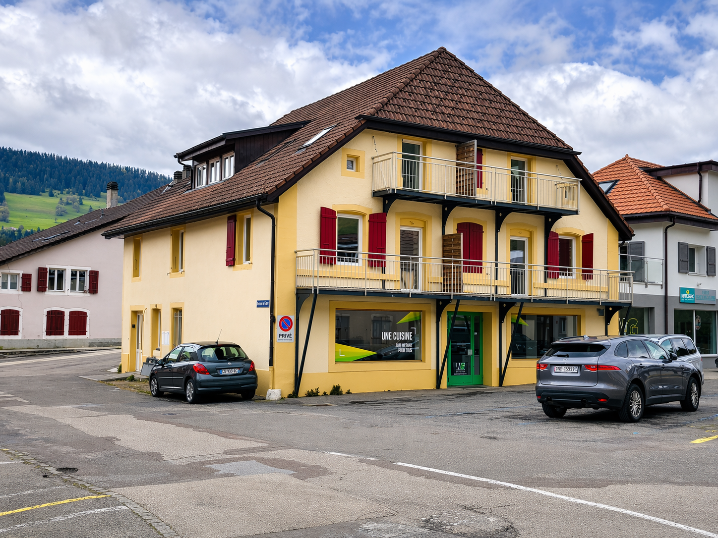yellow house, brown roof, red shutters, balcony, parking place