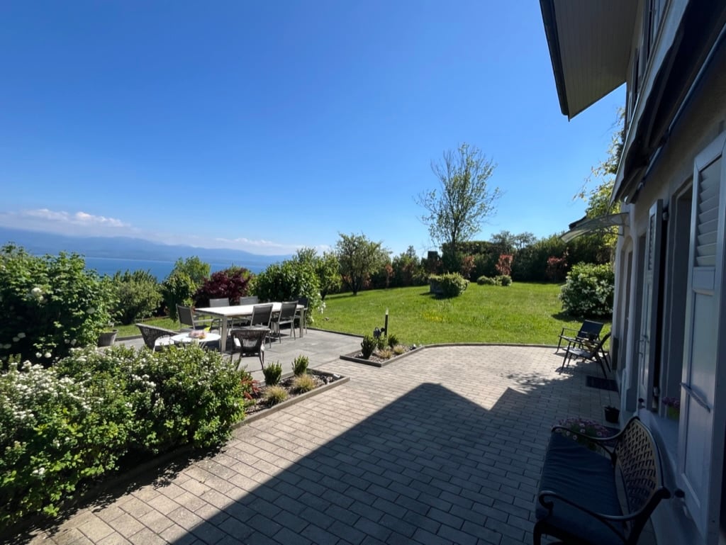 well manicured lawn, plants, trees, outdoor dining area, view of lake