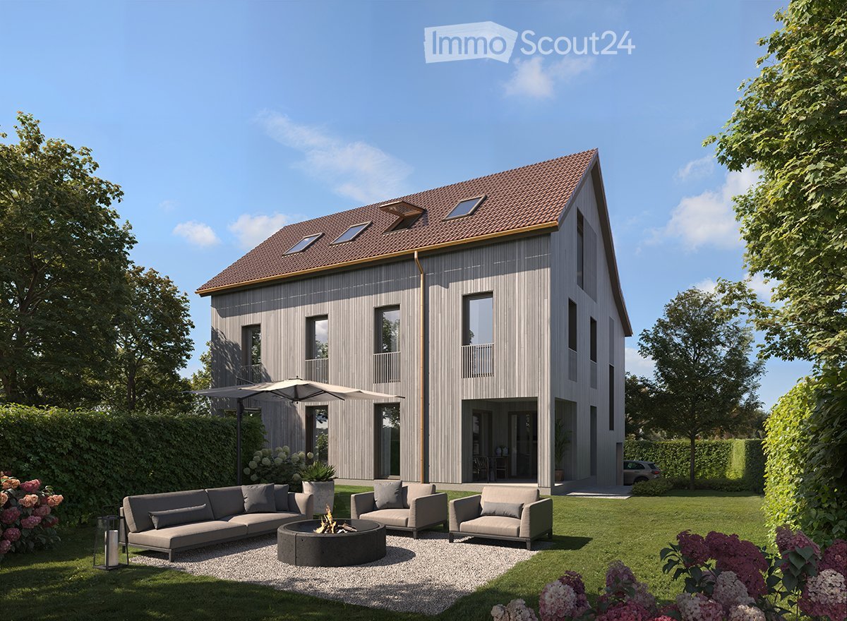 2-story modern house with gray wooden siding, red tile roof, large windows, balconies, and a patio area with outdoor furniture and a fire pit in the backyard surrounded by landscaping.