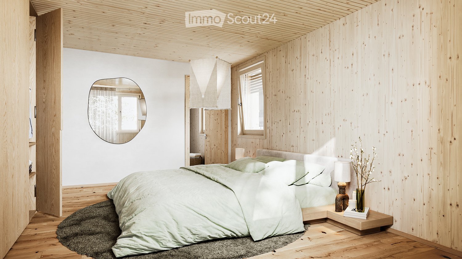 Bedroom with wooden walls and flooring, bed with light green comforter, round mirror, nightstand with lamp and flower vase, rug, wooden cabinet.