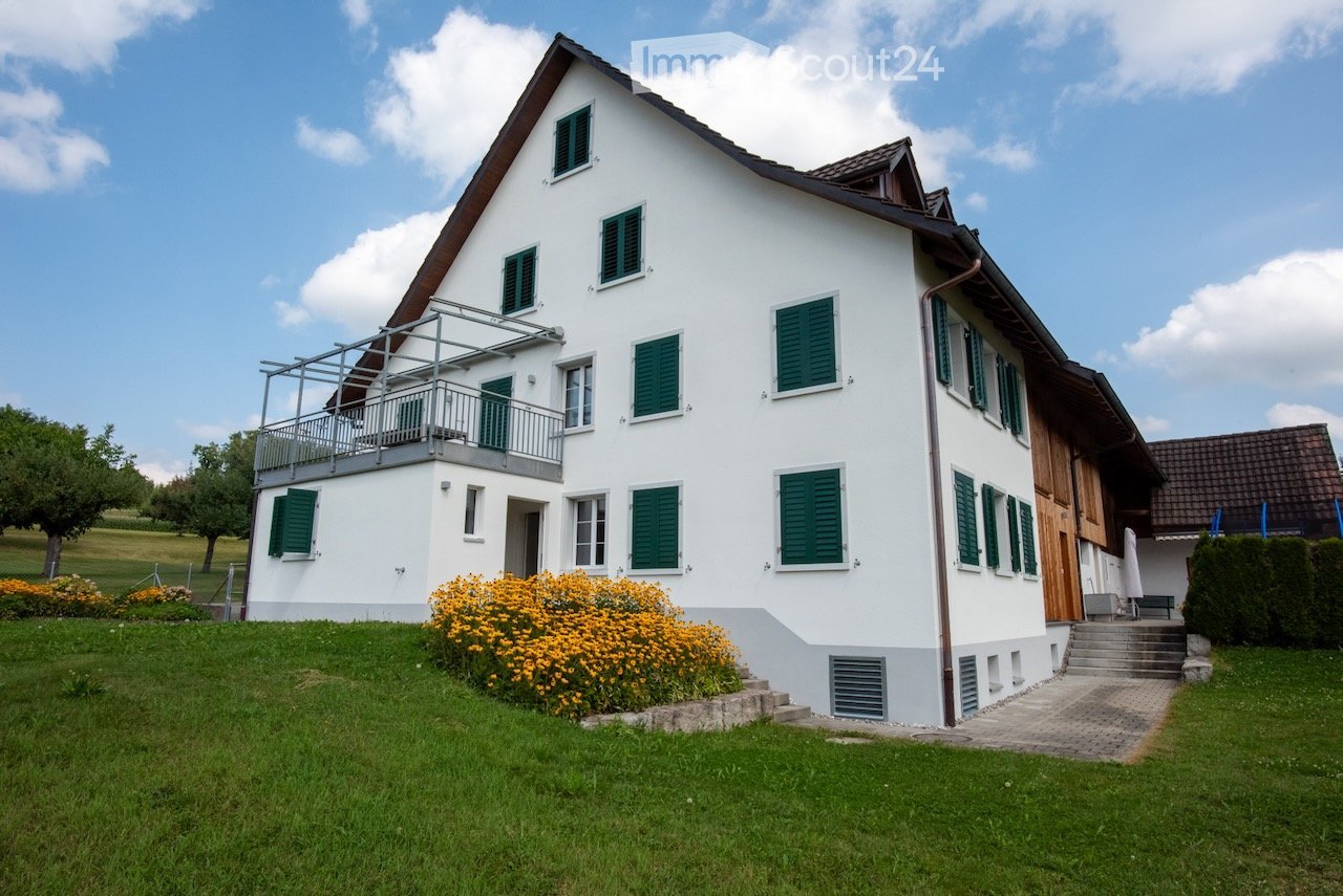 2 story house, white exterior, green shutters, balcony, garden, green grass