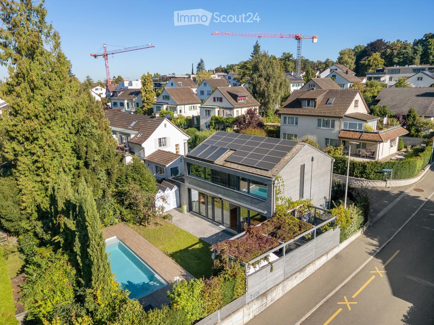 Modern house with solar panels, swimming pool, raised ground floor, balcony