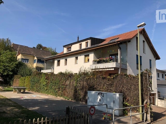 3 story house, white walls, red roof, fence, balcony, garden