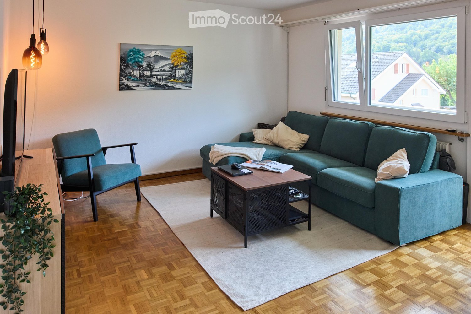 Blue couch, wooden coffee table, beige rug, blue chair, painting, modern design, large windows, wooden floor