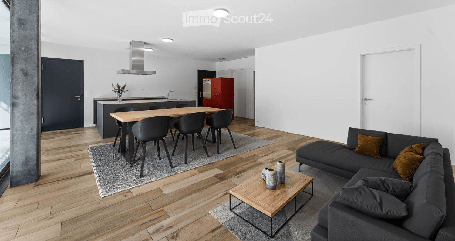 open floor plan, modern kitchen, dining table, L-shaped couch, wooden floor, white walls