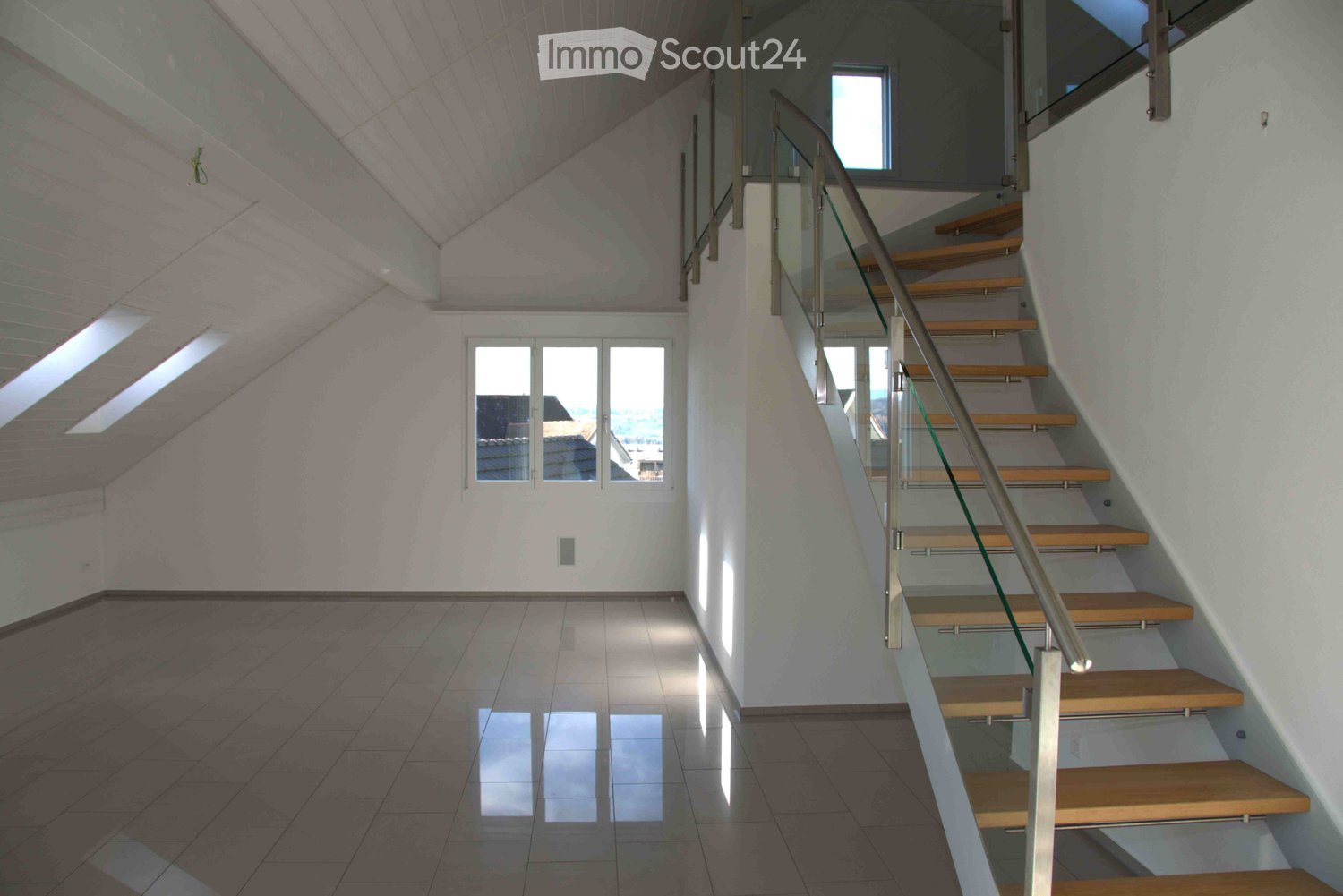 Tiled floor, white walls, staircase, glass window, sloped ceiling