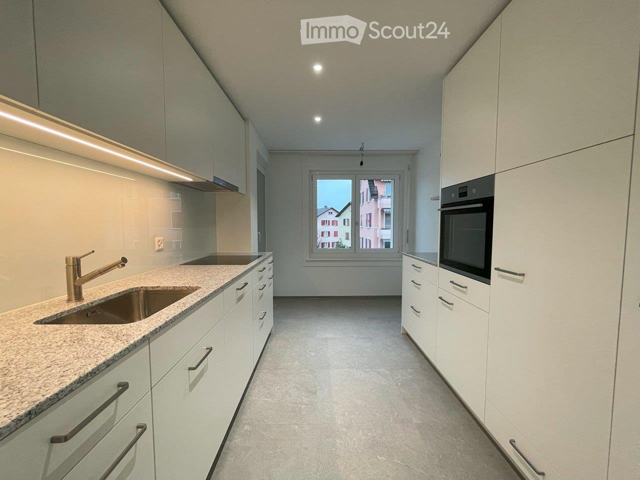 modern kitchen, granite countertop, stainless steel sink, oven, dishwasher, large window, white cabinets