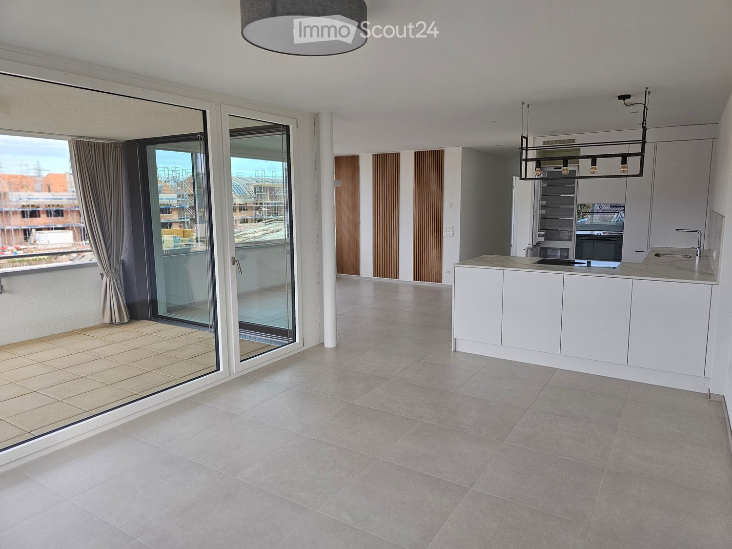 modern interior, open balcony with sliding glass doors, granite tiles, kitchen island with marble countertop, pendant light, large windows, modern appliances