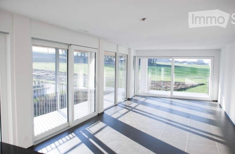 modern empty room, large windows, sliding doors, white walls, balcony, tiled floor