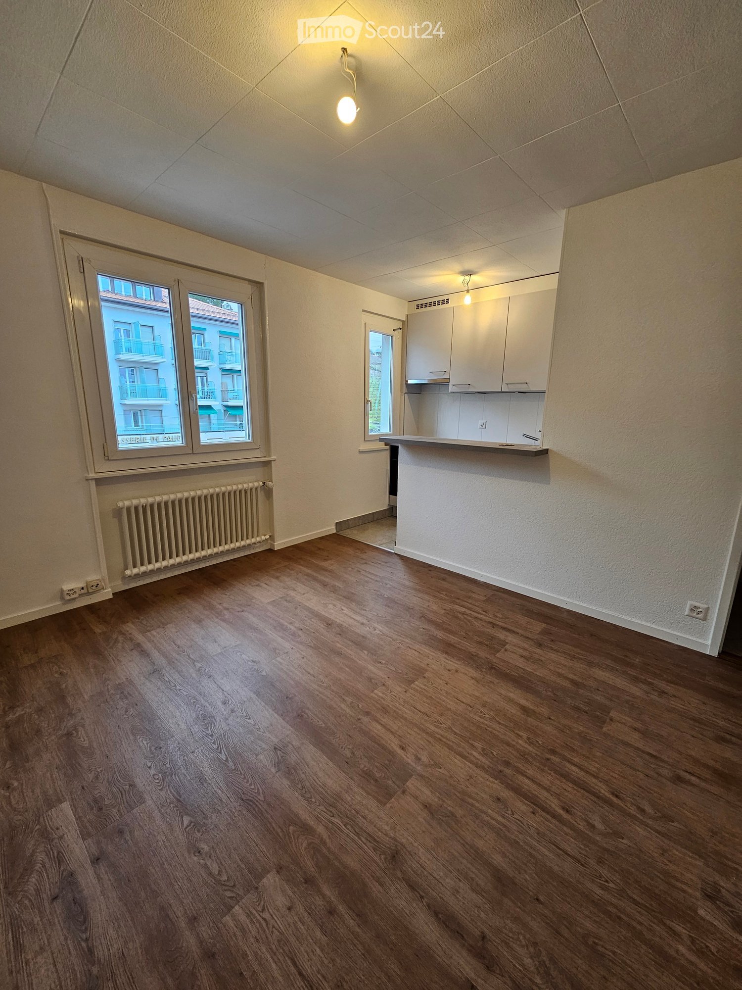 wooden floor, white walls, windows, radiator, kitchen area