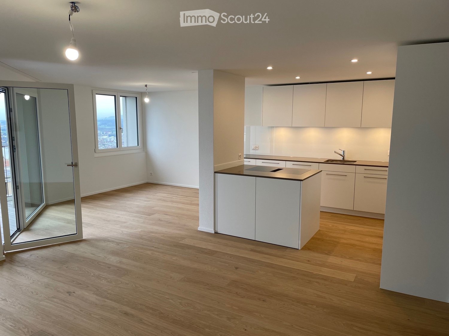 Kitchen with modern appliances and wooden floors, double doors with glass panel