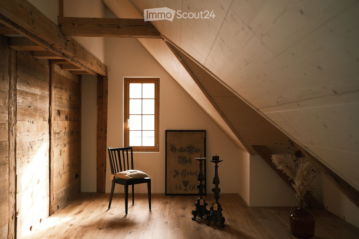small room, wooden beam ceiling, wooden plank wall, chair, pillow, painting, candle stand, window