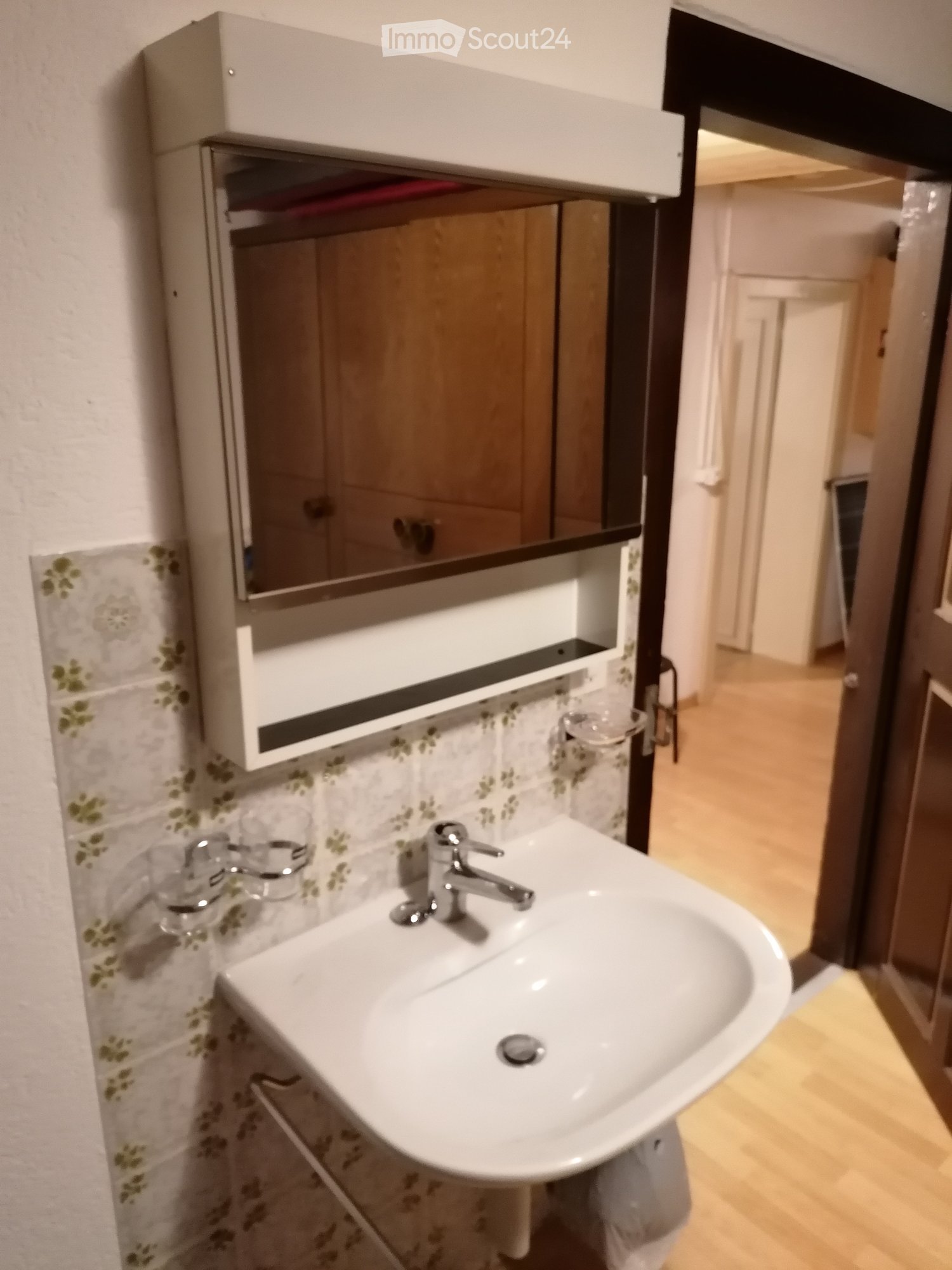 Sink with faucet and mirror cabinet, white ceramic sink, glass holder for cups, floral wall tiles