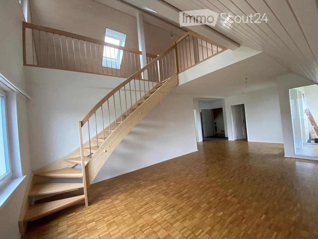wide staircase, raised ground floor, white walls, wooden parquet flooring