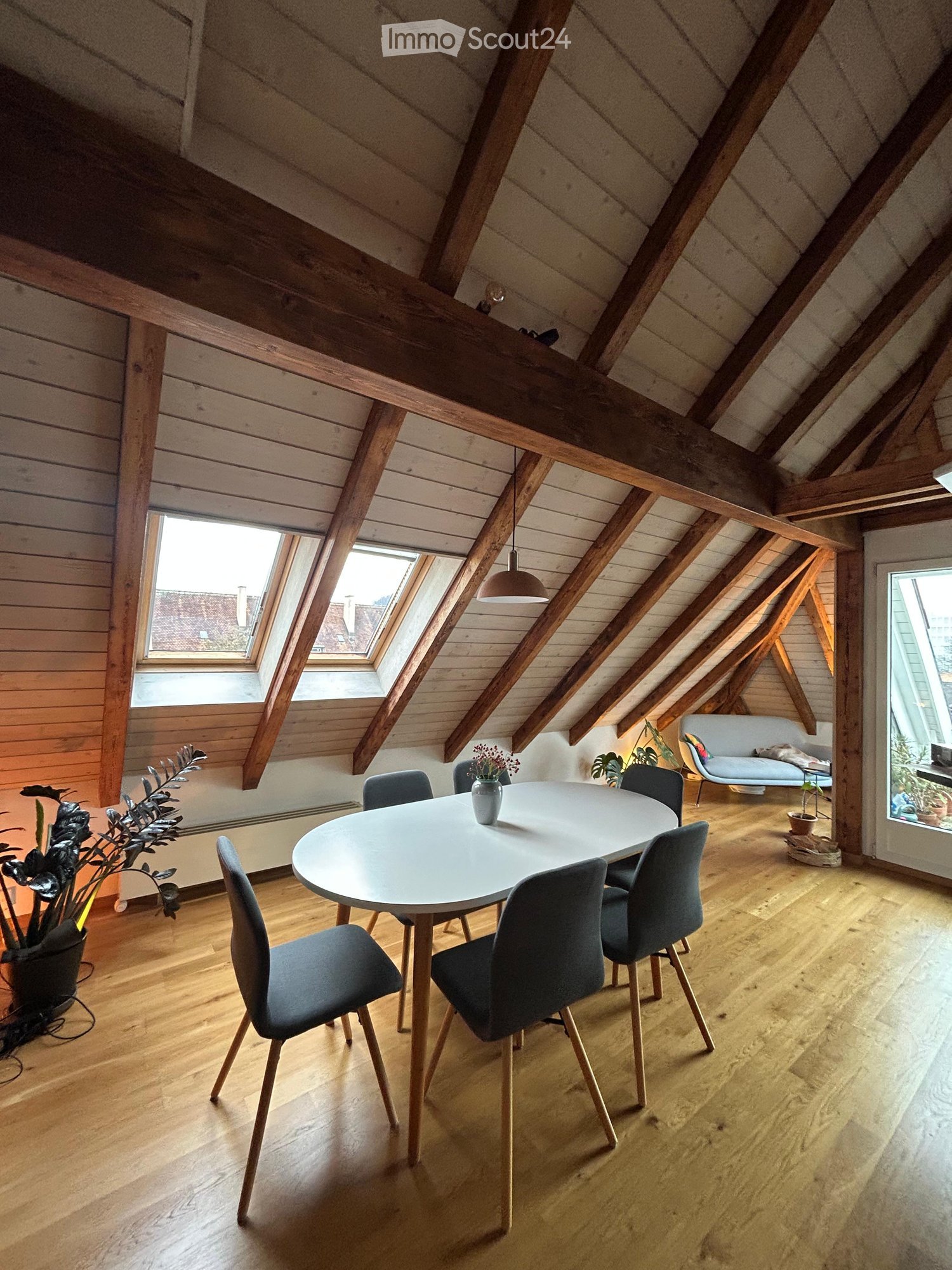 dining room with 4 chairs, wooden table, large skylights, ceiling beams, floor