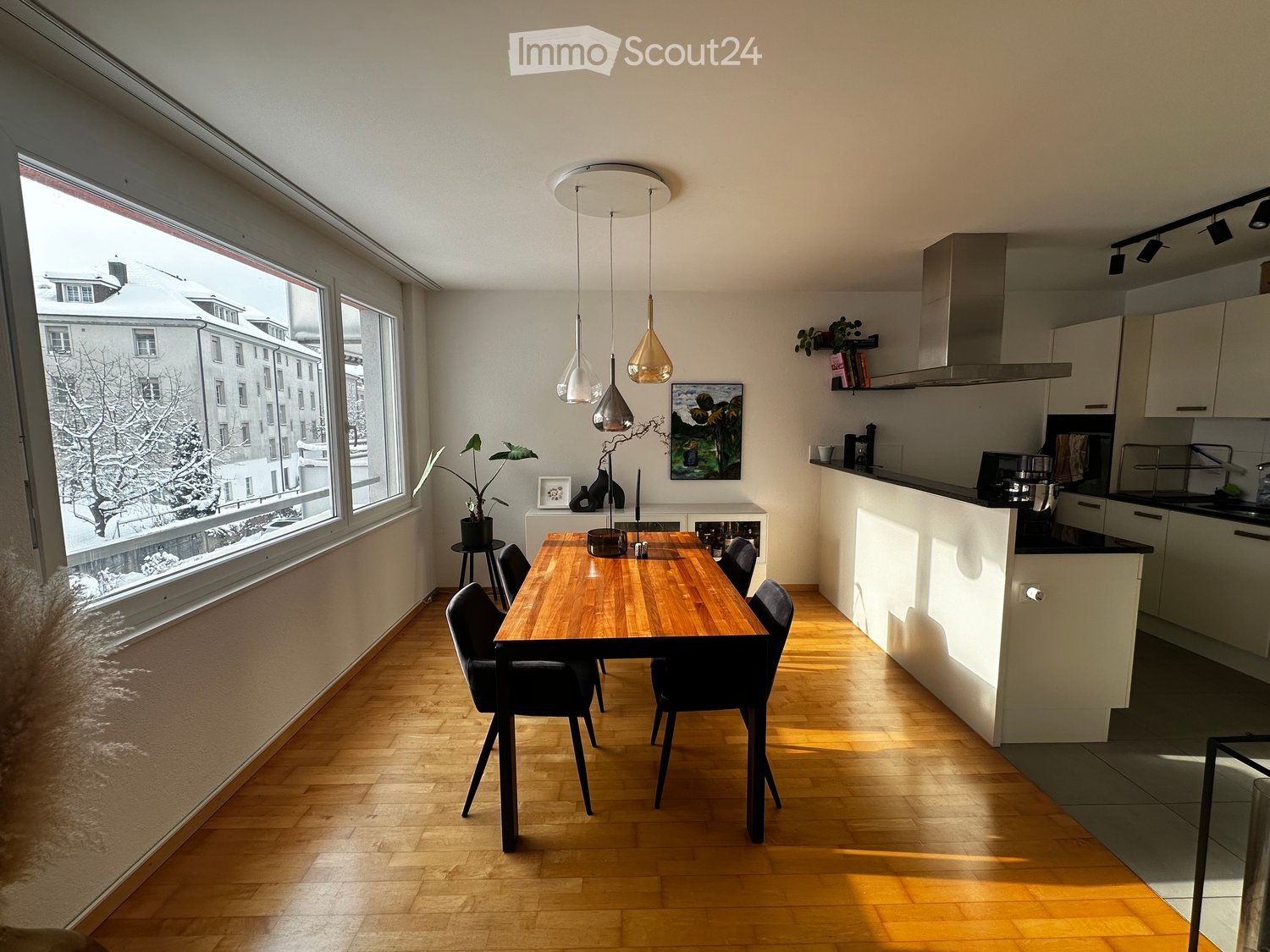 Wooden floor, modern dining table, black chairs, large windows, kitchen island, open kitchen, modern decor