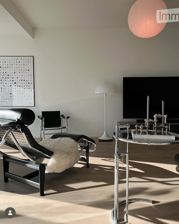 modern furnishings, flatscreen television, decorative table, decorative chair, minimalist design, light colored floor