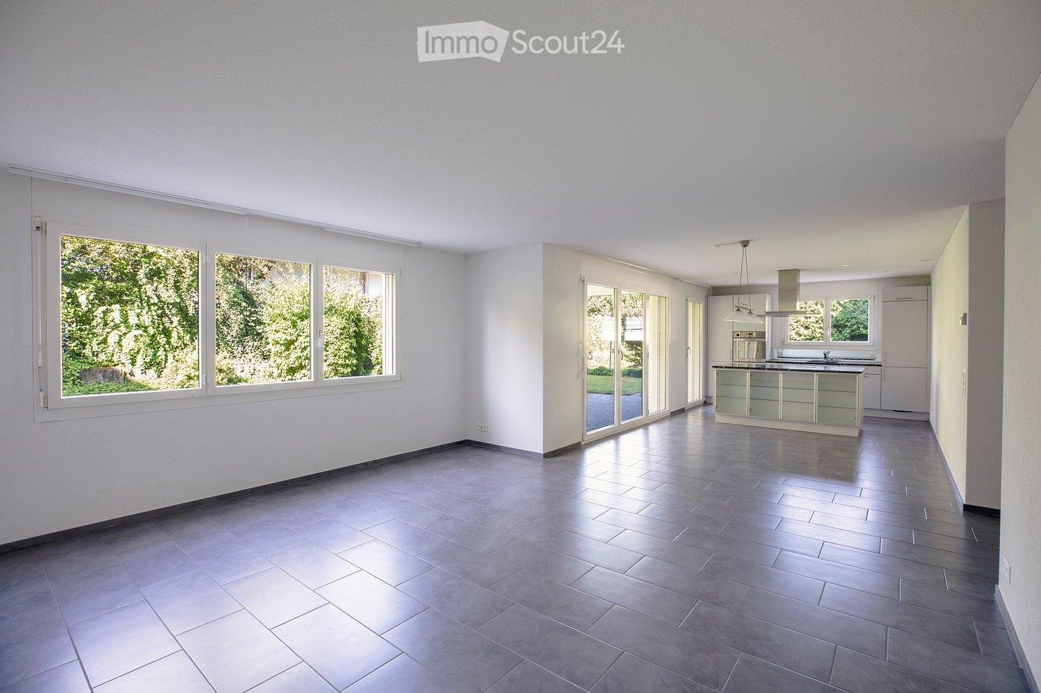 Modern interior design, large windows with sliding glass doors, grey tiled floor, contemporary kitchen