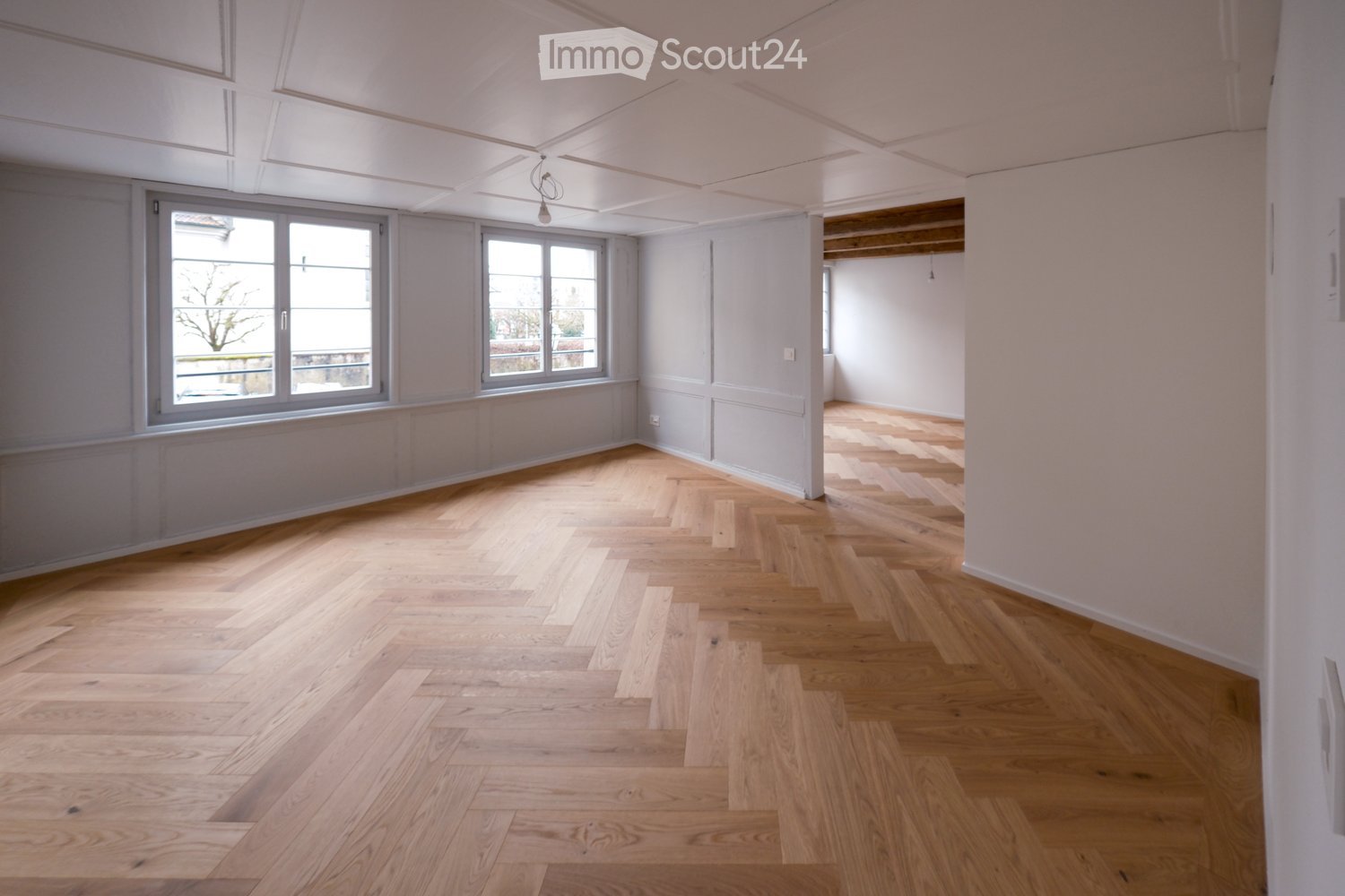 wooden herringbone flooring, white walls, glass windows, white ceiling