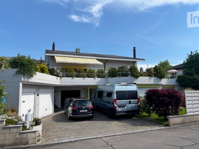 Two-story house, white exterior, garage, yellow awning, two cars parked in front
