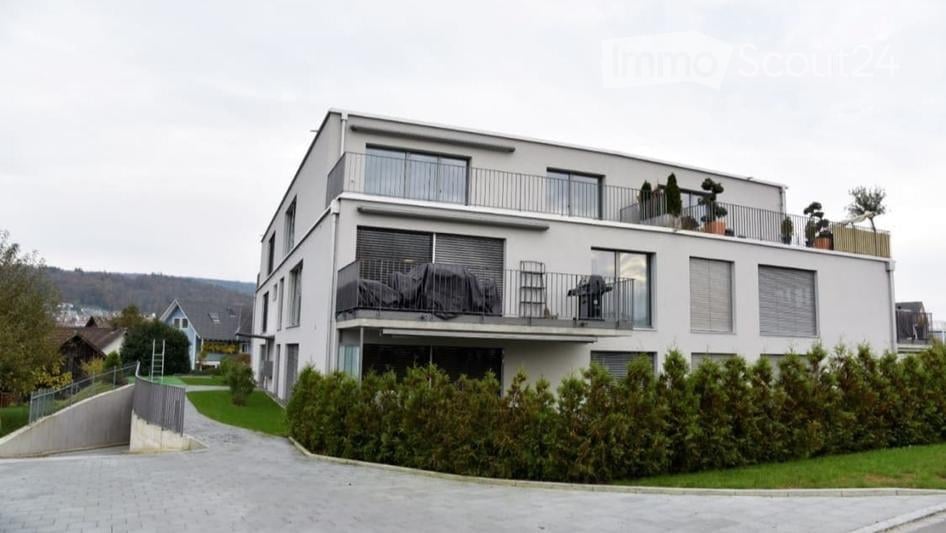 two-story white building, glass windows, balcony, plants, shrubs, trees, concrete driveway
