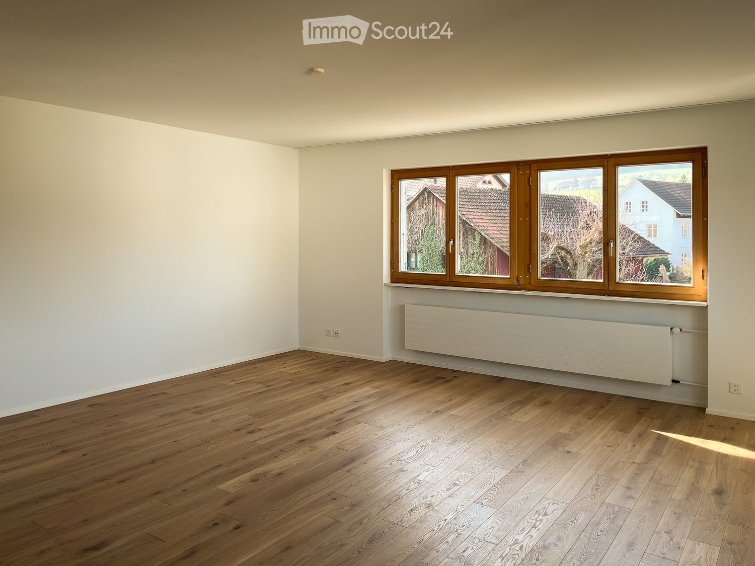 empty room, white walls, wooden floors, windows with view