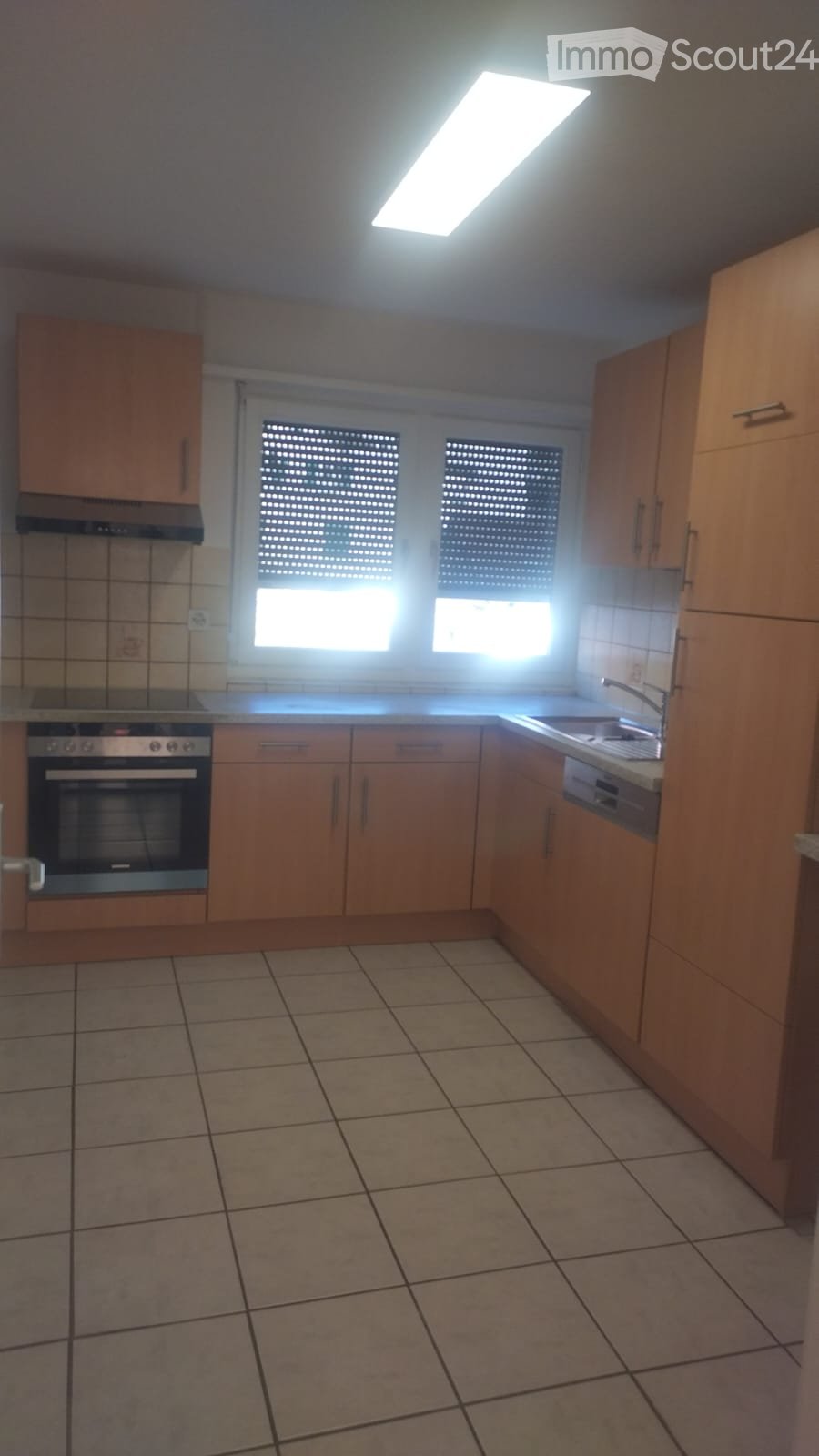 Kitchen, oven, stove, dishwasher, sink, windows, wooden cabinets, tiled floor