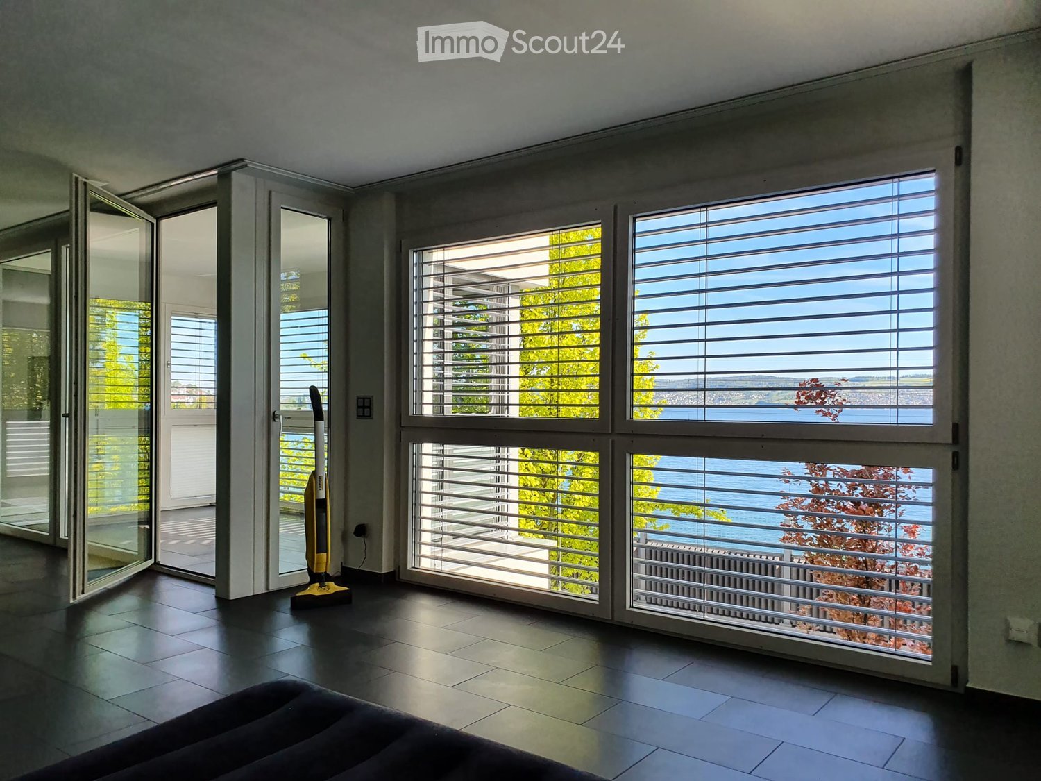 large windows, water view, tiled floor, balcony, sliding glass doors