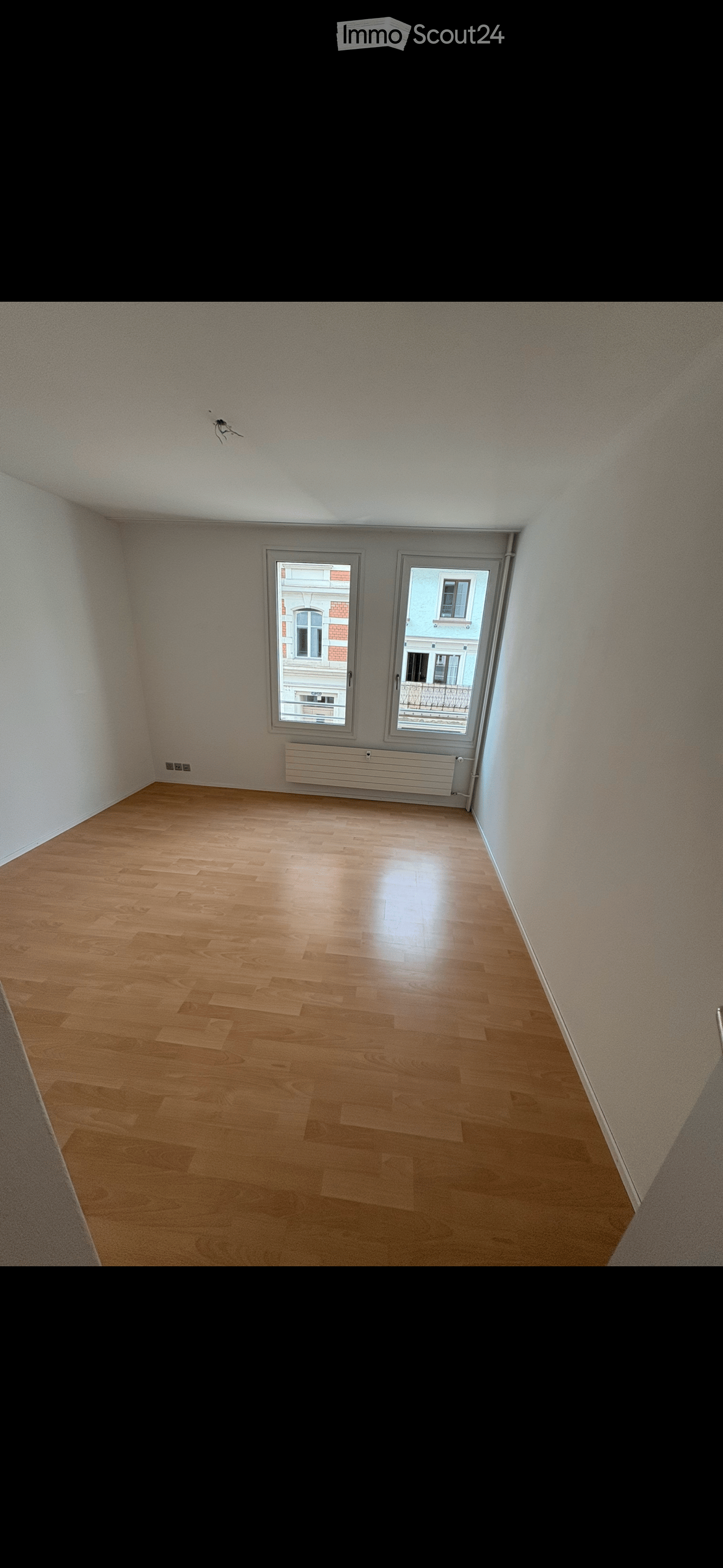 empty room, wooden floor, white walls, two windows, balcony