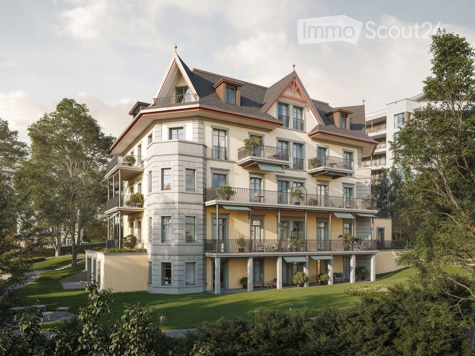 3 story house, yellow and white facade, multiple balconies, green lawn, trees