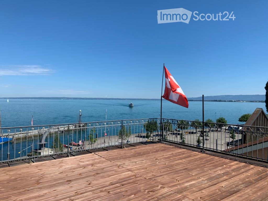 wooden deck, metal railing, flag, view of the sea