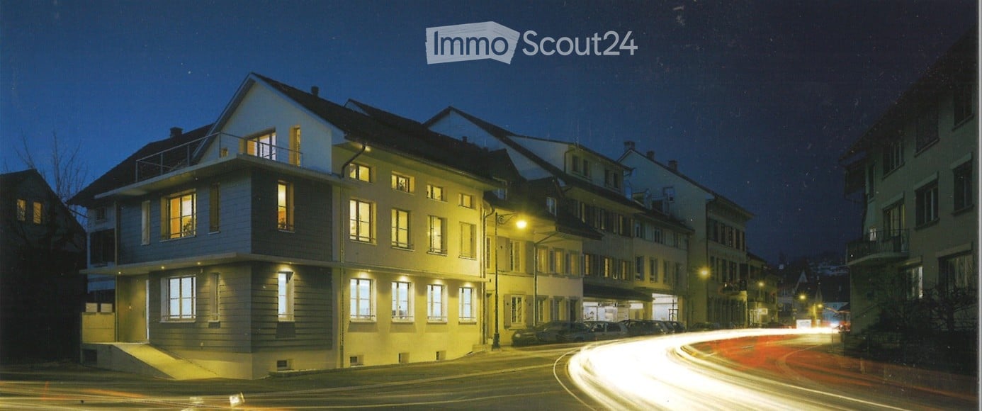 3 story house, white exterior, multiple windows, balcony, street lights, cars parked