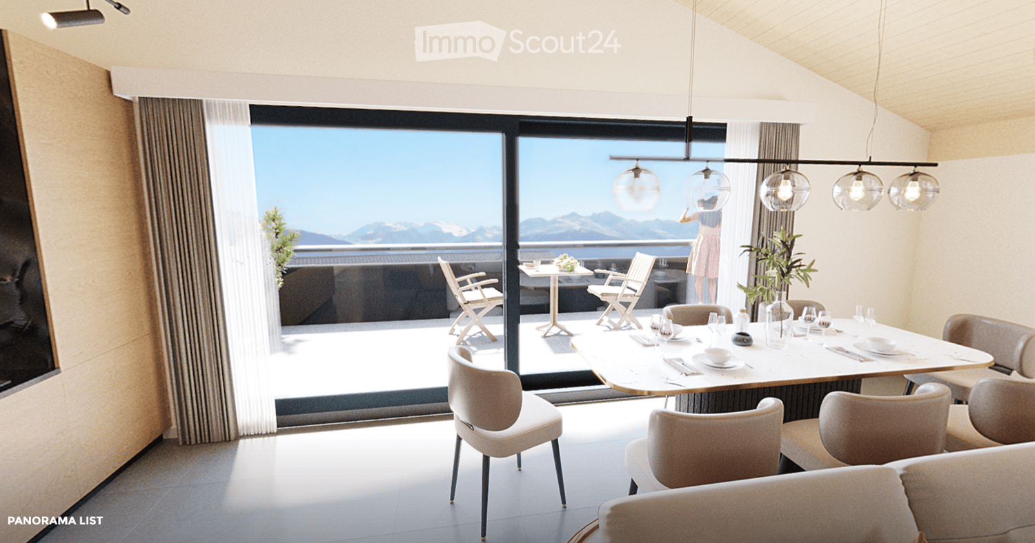 Modern dining area with a large table, chairs, pendant lights, and a view of mountains through large windows.