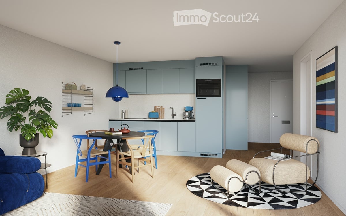modern kitchen with dining area, blue cabinets, wooden floor, round table, blue chairs, blue sofa, potted plant, microwave, kettle, coffee machine, rug, lamp