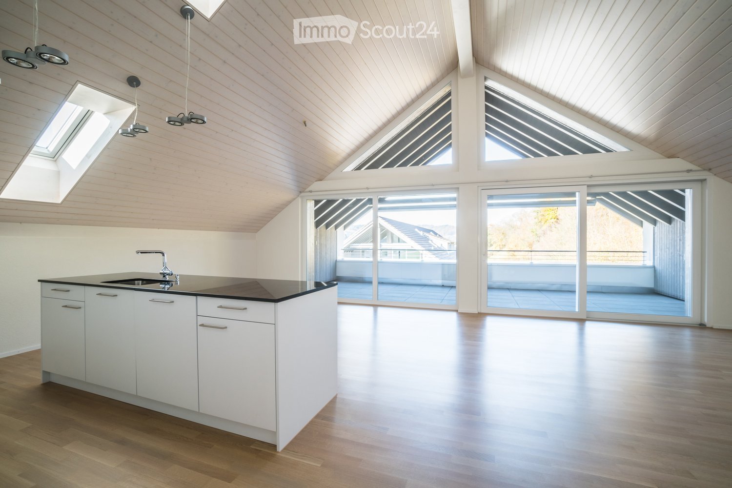modern kitchen with white cabinets, black countertop, sink, faucet, wooden floor, large windows, balcony