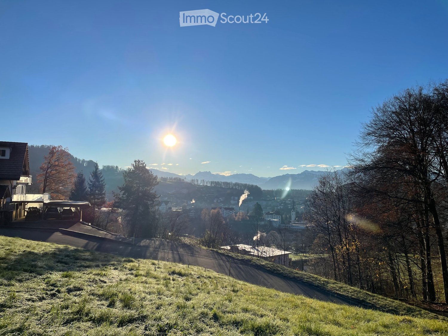 Wide view of hills, mountains, and a small town in the distance
