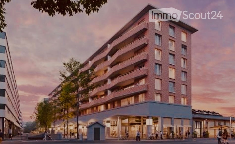 Modern multi-story apartment building with red brick facade, balconies, and a ground-floor commercial area with outdoor seating.