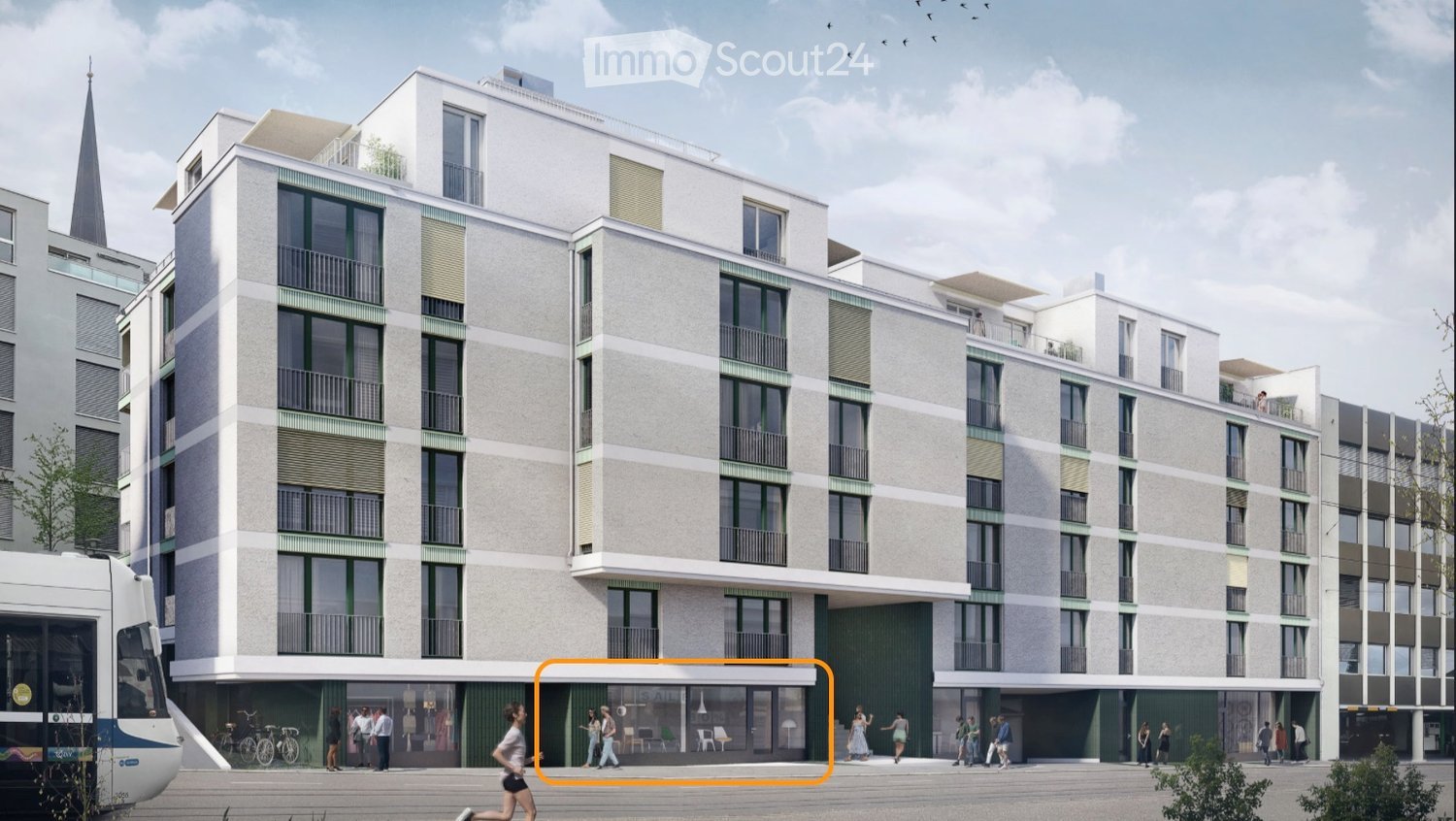 Modern multi-story residential building with balconies, large windows, and a contemporary design. The ground floor features a commercial area with seating and a tram passing by.