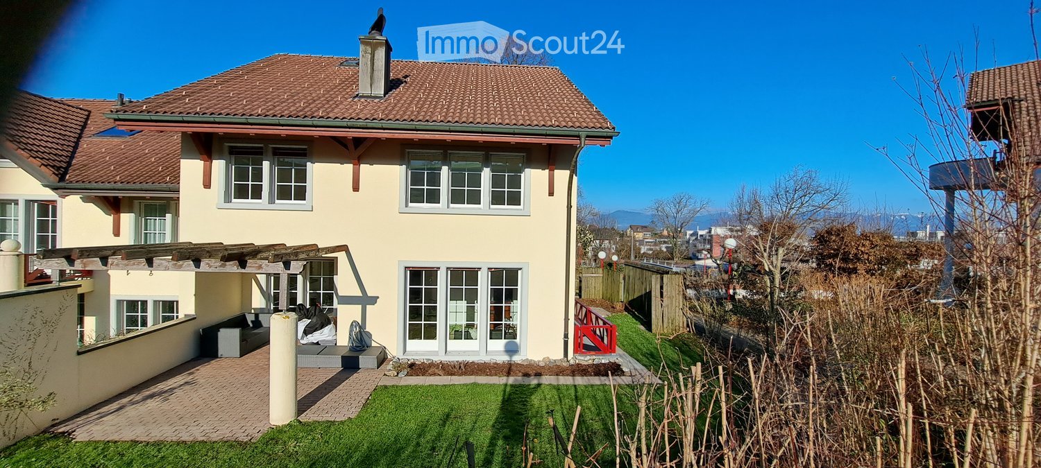 2 story house, brown roof, large windows, wooden pergola, garden, patio, lawn