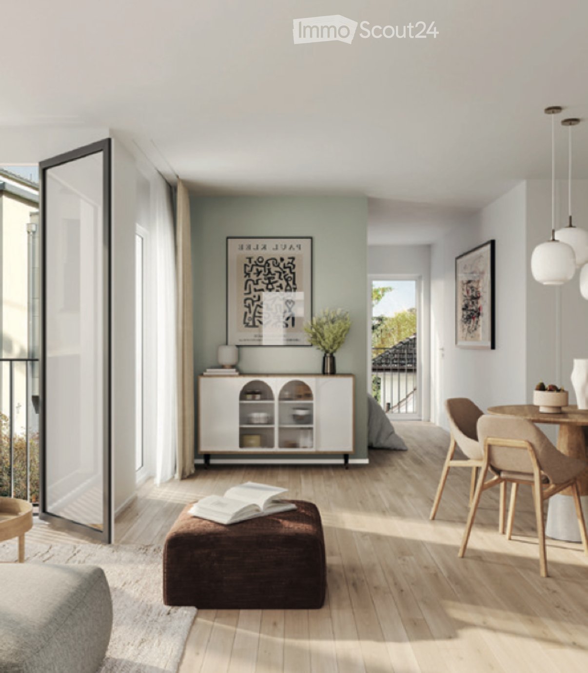 Modern living room with light wood flooring, a grey sofa, a brown ottoman with books, a small wooden table with chairs, a white cabinet with glass doors, and a vase with flowers on the cabinet.