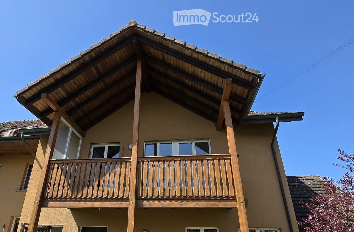 wooden balcony, brown roof, brown walls, glass windows