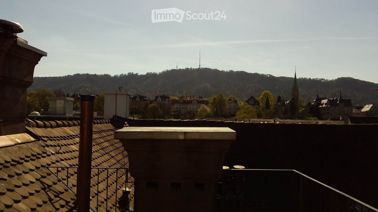 Rooftop with view of town and mountain range in the distance