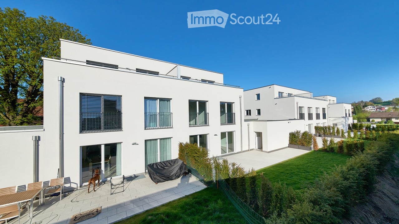 White modern townhouse, with glass balcony, garden, patio, large windows